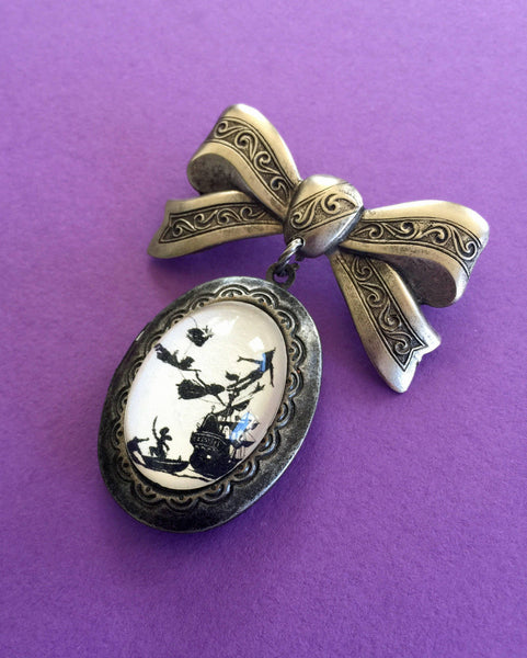 PETER PAN Brooch - locket pendant on bow pin - Silhouette Jewelry